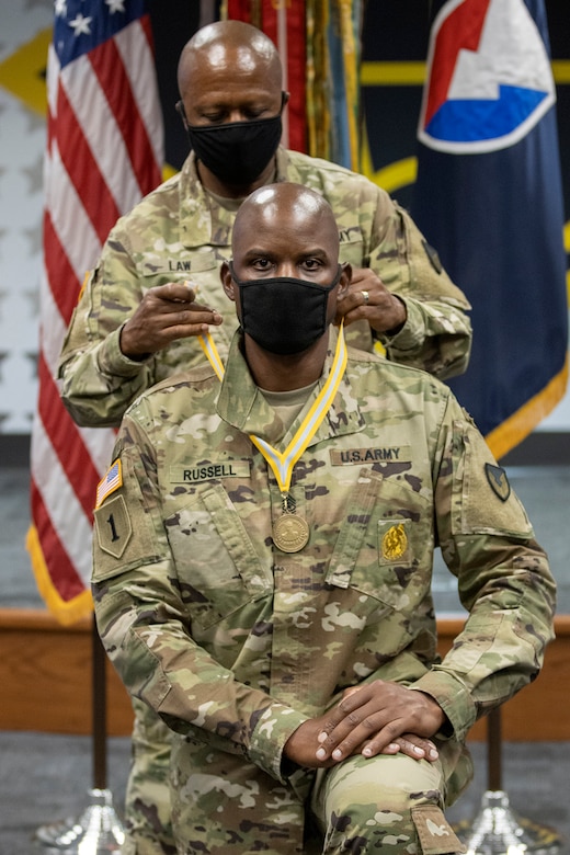 Command Sgt. Maj. Kenneth F. Law, U.S. Army Financial Management Command senior enlisted advisor, presents Sgt. Maj. Damien Russell, USAFMCOM Operations senior enlisted advisor, with the 837th Maj. Gen. Nathan Towson Medallion during a special ceremony at the Maj. Gen. Emmett J. Bean Federal Center in Indianapolis Aug. 26. The Towson Medallion was established by the Army Finance Corps Association on May 7, 1993, and is awarded in recognition of demonstrated exemplary contribution and service to the Army Finance Corps. (U.S. Army photo by Mark R. W. Orders-Woempner)