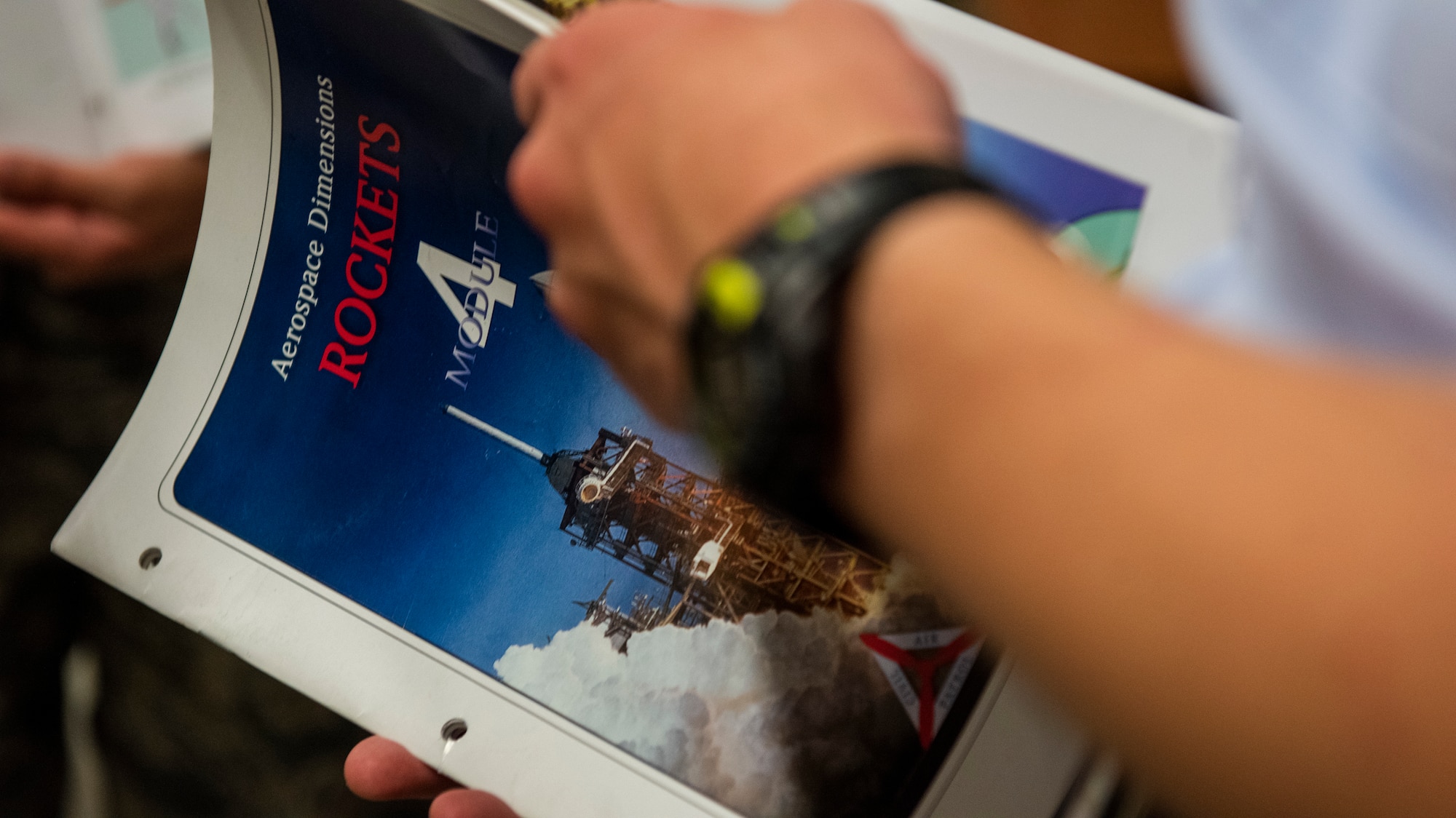 A member of Civil Air Patrol Unit 2801’s cadet training squadron holds an educational module about rocketry