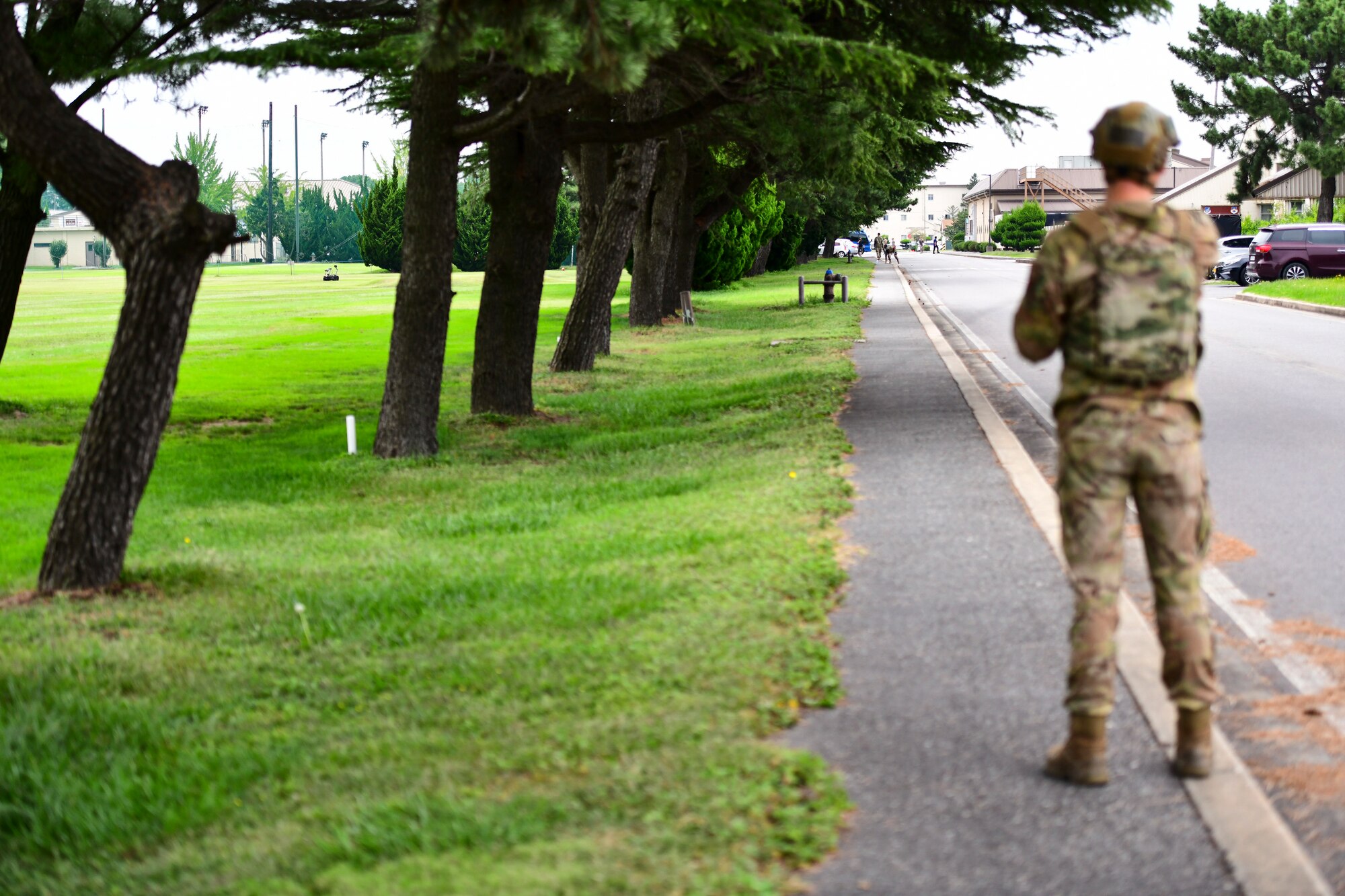An Airman watches a robot move.