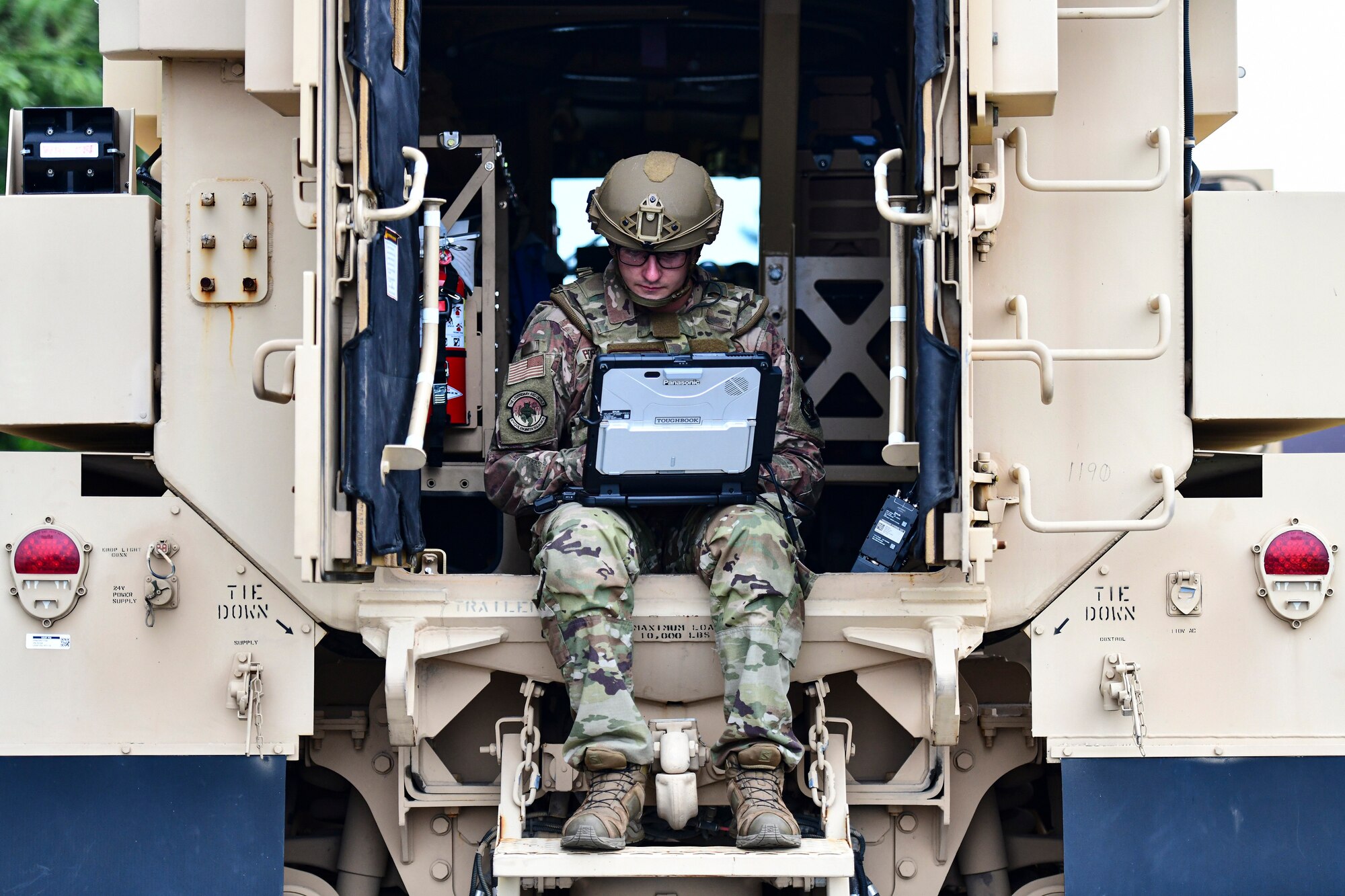 An Airman operates a robot.