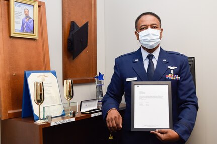 Lt. Col. Ivan Edwards, 433rd Aerospace Medicine Squadron flight surgeon, displays his Royal Society of Arts selection letter in his office at the 433rd Medical Group building on Joint Base San Antonio-Lackland, Texas, Sept. 21, 2021. Edwards joined the U.S. Air Force Reserve in 2004 as a flight surgeon. (U.S. Air Force photo by Senior Airman Brittany Wich)