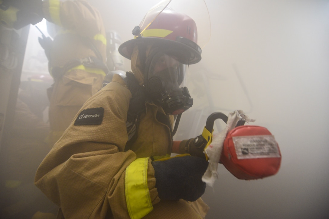 Damage Controlman Fireman Rebecca Sommers, from Miami, stands re-flash watch as part of a damage control drill during UNITAS LXII, Sept. 27, 2021.