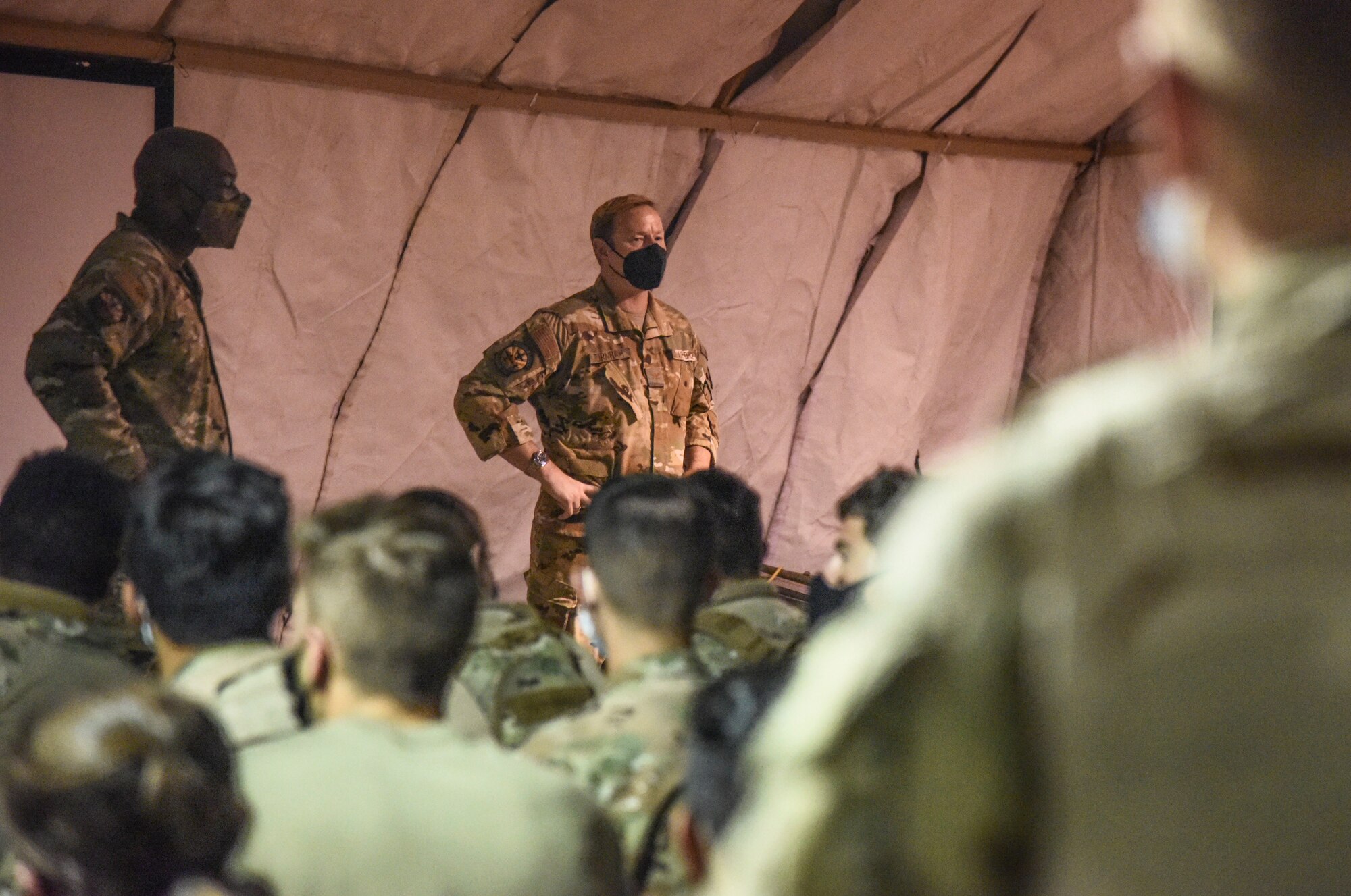 Pictured above are two Airmen speaking to a large group of Airmen.
