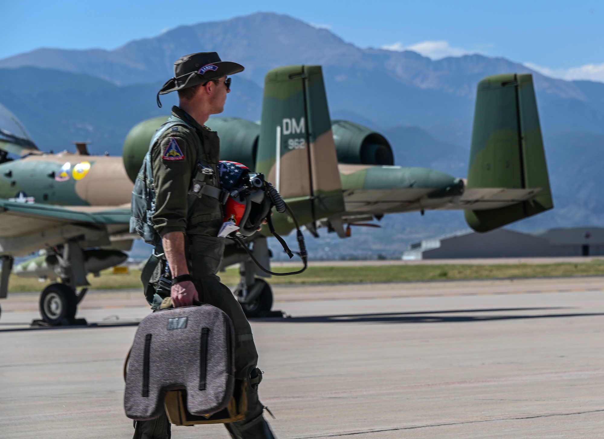 A photo of a pilot walking across the flight line