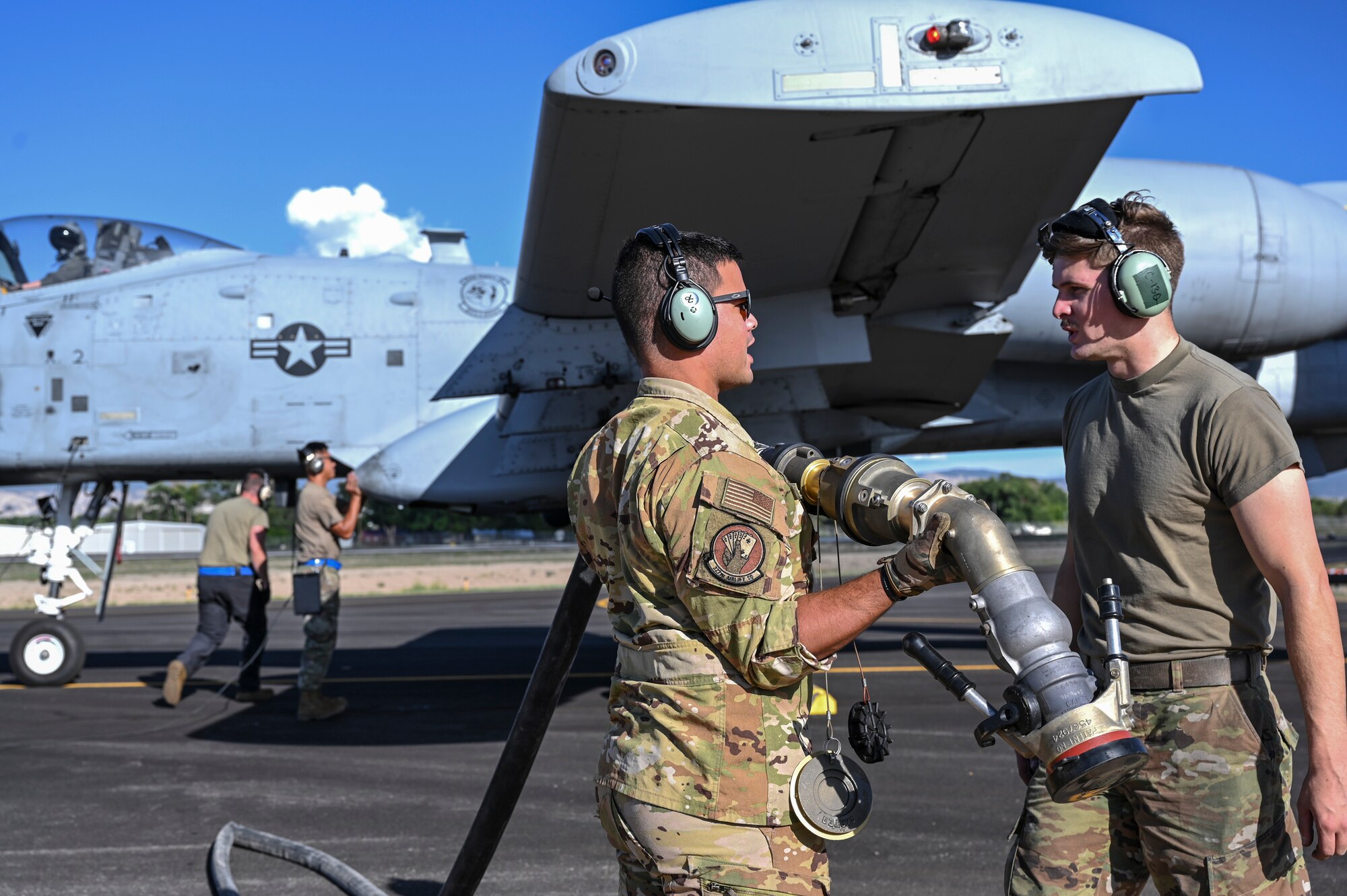 A photo of an Airman holding a fuel line