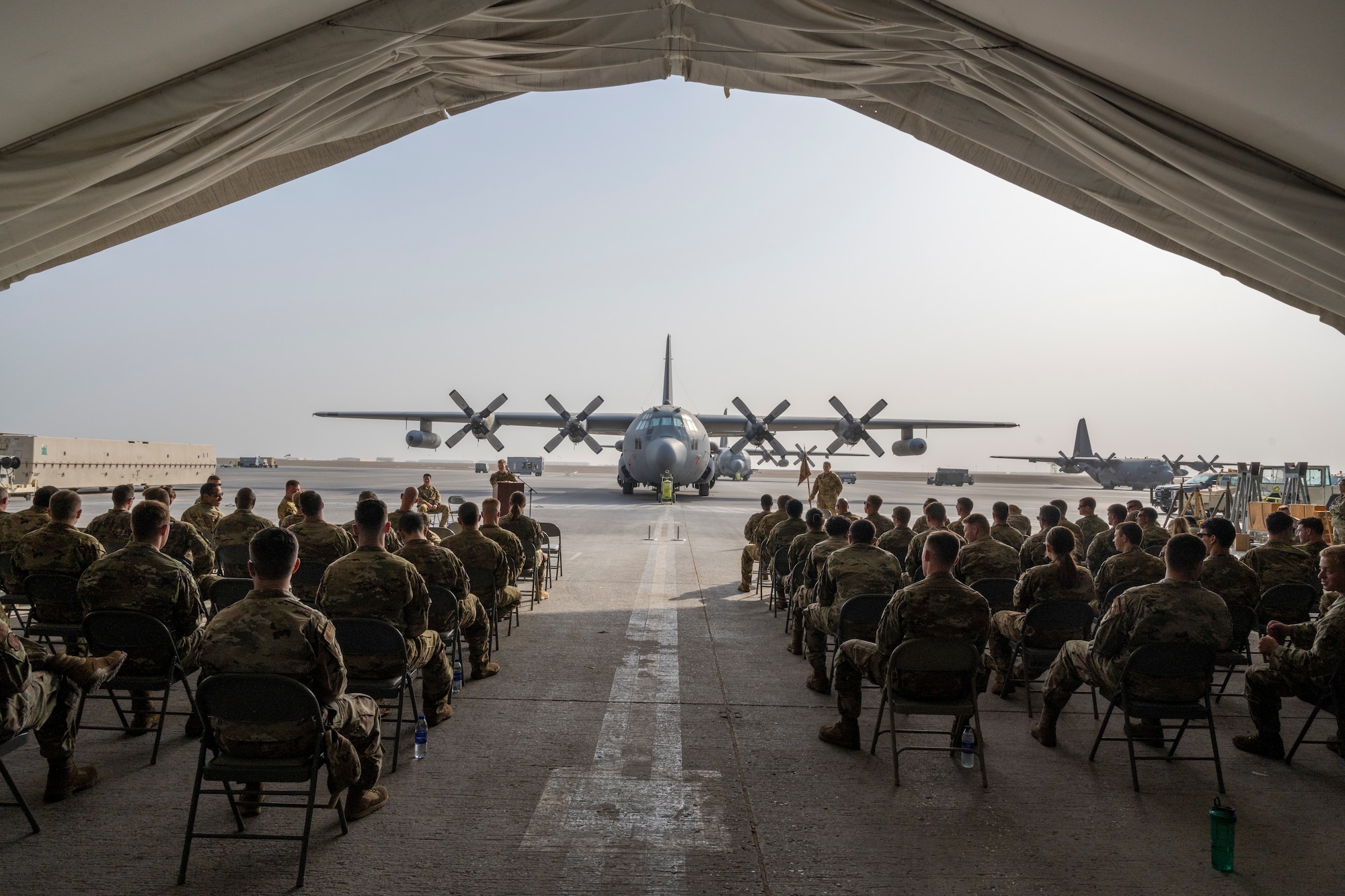 Seated audience and EC-130H aircraft