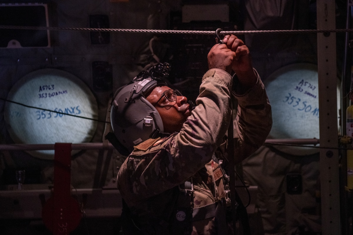 U.S. Air Force Master Sgt. Travis Dulworth, 1st Special Operations Squadron loadmaster, secures parachute rigging after the final airdrop was made during a flight off the coast of Japan, Sept. 15, 2021. Loadmasters maintain a safe and secure environment in the back of the aircraft while pilots in the cockpit focus on flying.
