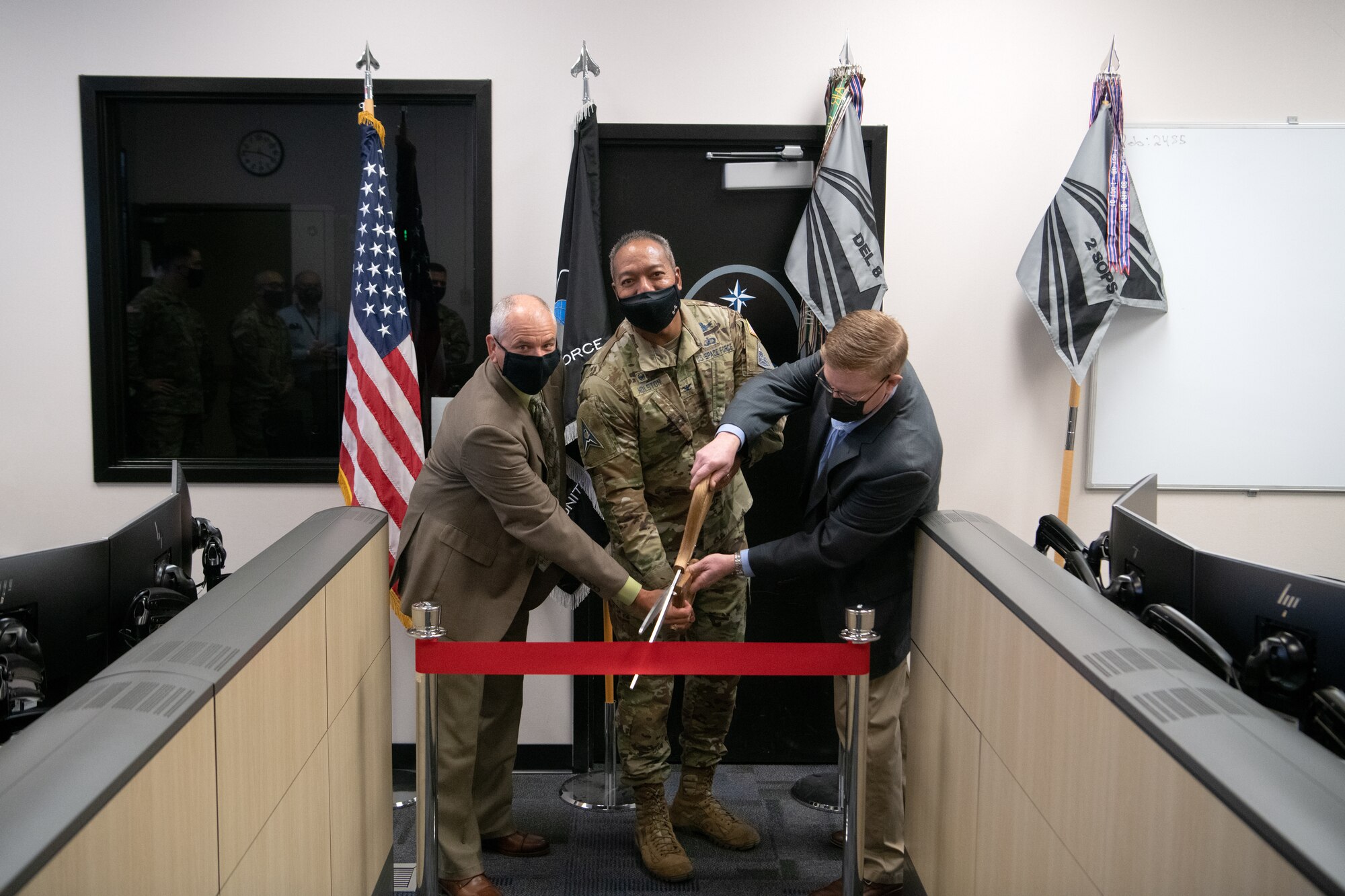 SCHRIEVER SPACE FORCE BASE, Colo. — U.S. Space Force Col. Matthew Holston, Space Delta 8 - Satellite Communications and Navigational Warfare commander (middle), Mr. Joseph Gambrell, Positional, Navigation and Timing area team lead (left), and Mr. Bruno Mediate, Space Systems Command (right), cut a ribbon to officially open the Positional Training Emulator on Schriever Space Force Base, Colorado, Sept. 17, 2021. Once fully operational, the PTE will be used during mission qualification training and upgrade courses, as well as be used to ready operators for advanced missions and currency training. (U.S. Space Force photo by Staff Sgt. Jared Bunn)