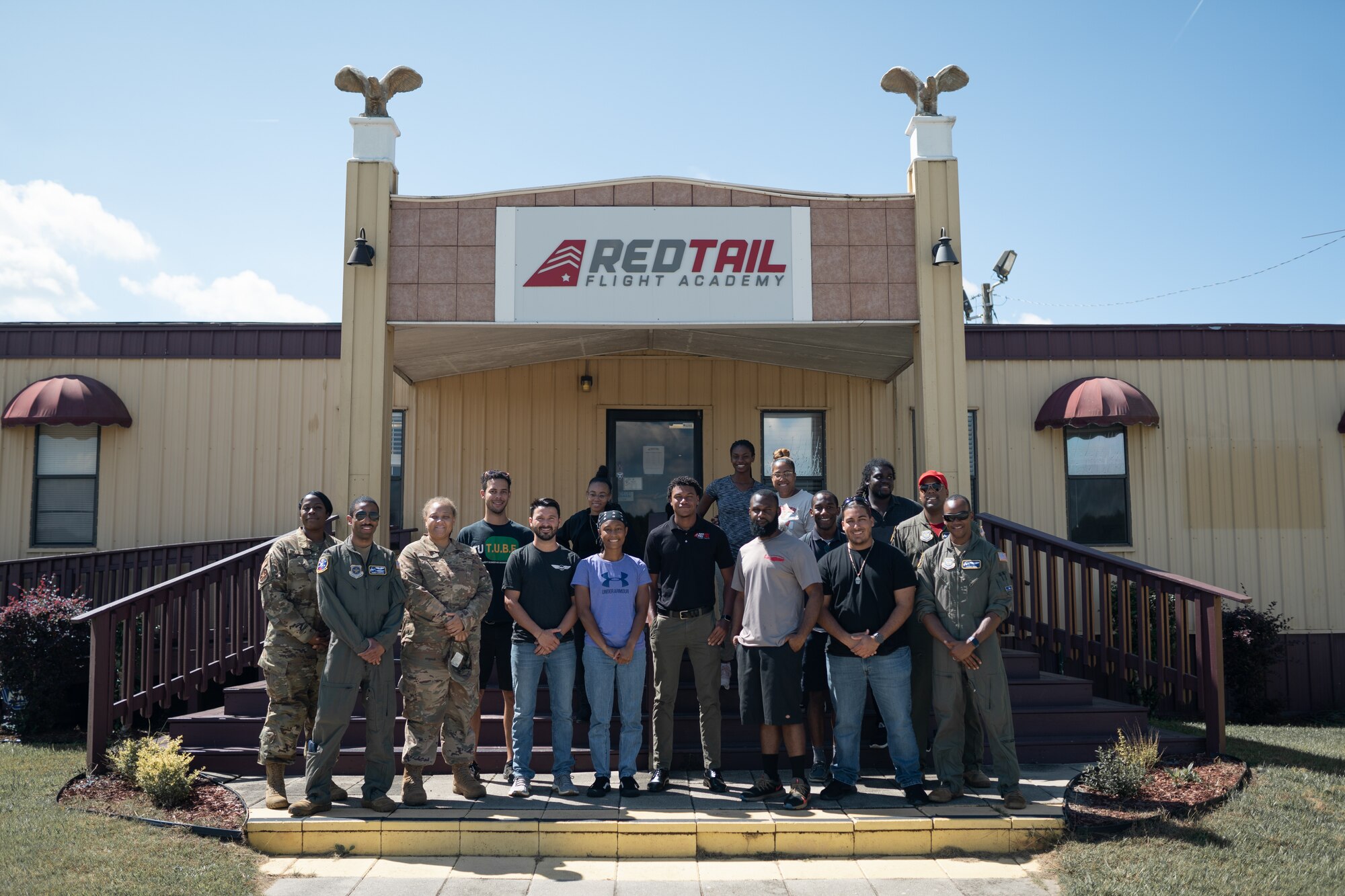 U.S. Air Force pilots and crew from the 458th Airlift Squadron, Scott Air Force Base, Illinois, pose for a photo alongside students from the Red Tail Flight Academy, Tuskegee, Alabama, Sept. 28, 2021. The school’s campus is on the same airfield the legendary Tuskegee Airmen trained at over 80 years ago and trains new students pilots interested in building flight time and learning more about aviation. (U.S. Air Force photo by 1st Lt. Sam Eckholm)