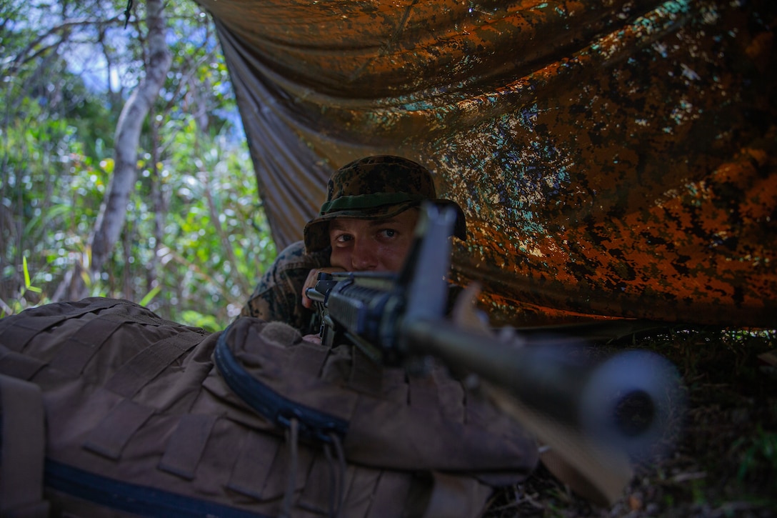 U.S. Marine Corps Cpl. Jacob Nichols, an assault amphibious vehicle crew chief with 3d Assault Amphibious Battalion, currently attached to 4th Marines, sets security during patrol operations at the Basic Jungle Survival Course on Camp Gonsalves, Okinawa, Japan, September 2, 2021. BJSC prepares Marines and joint partners to fight in jungle environments. Nichols is a native of Pittsburgh, Pennsylvania. (U.S. Marine Corps photo by Lance Cpl. Jonathan Willcox)