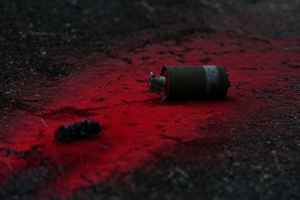 A grenade lays on the ground.