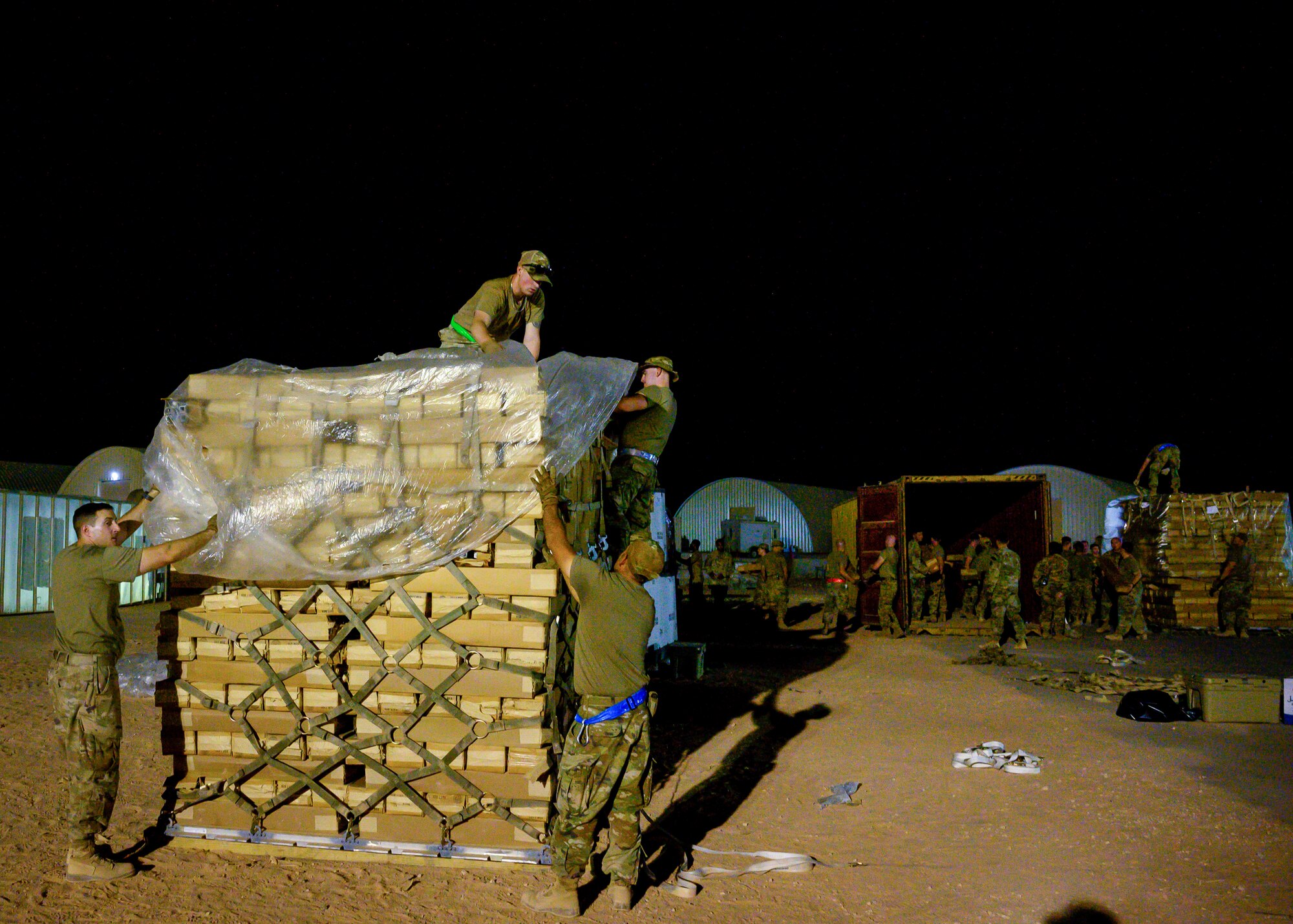 U.S. Air Force personnel build pallets of cots at Prince Sultan Air Base, Kingdom of Saudi Arabia, to be sent to Al Udeid Air Base, Qatar, in support of evacuation efforts, Aug. 20, 2021. The 378th Air Expeditionary Wing provided air support, logistics, manpower and resources to U.S. Air Forces Central in support of the evacuation of American citizens, special immigrant visa applicants and other at-risk individuals from Afghanistan. (U.S. Air Force photo by Senior Airman Samuel Earick)