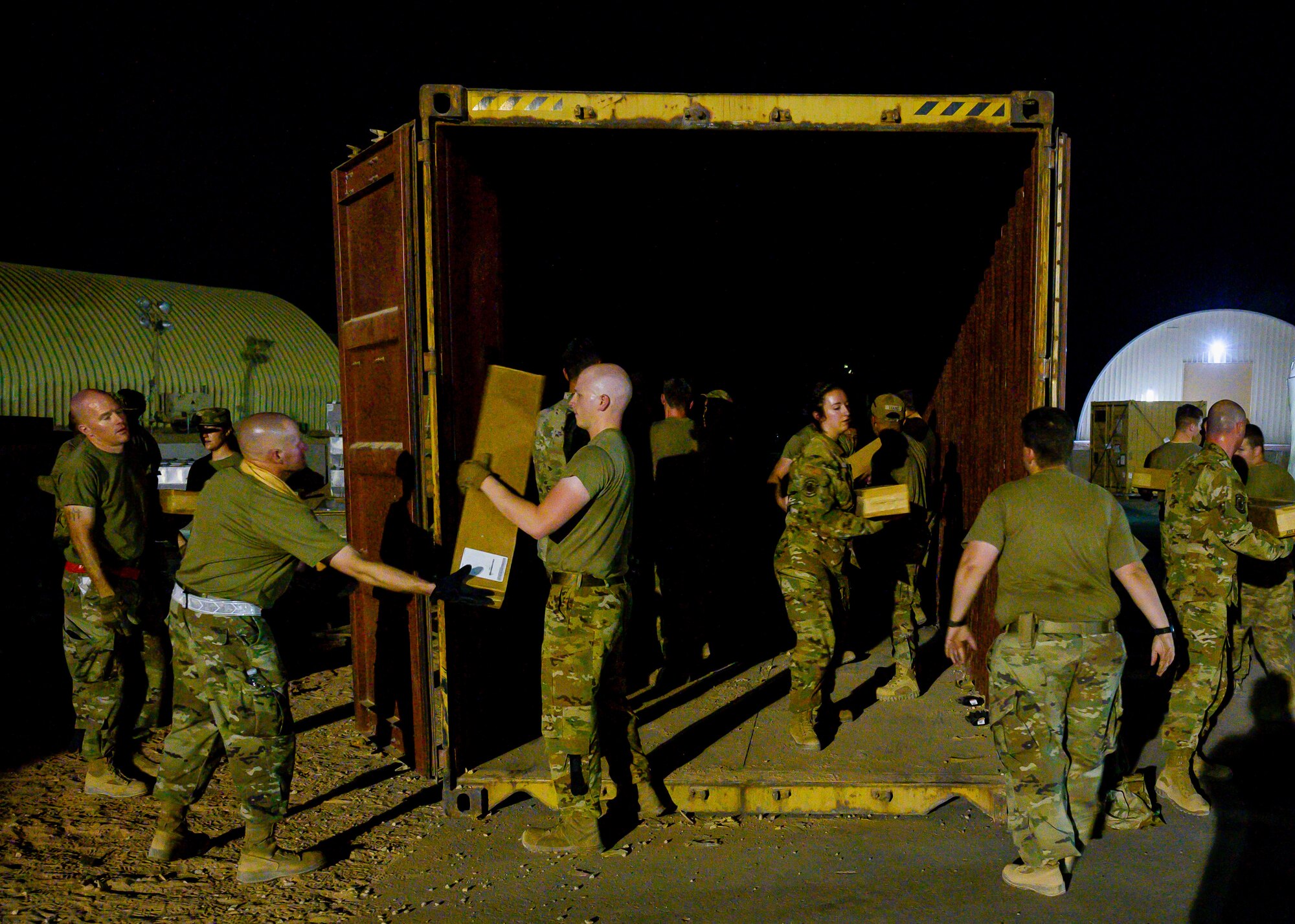 U.S. Air Force personnel unload cots to be sent on pallets to Al Udeid Air Base, Qatar, at Prince Sultan Air Base, Kingdom of Saudi Arabia, Aug. 20, 2021. The 378th Air Expeditionary Wing provided air support, logistics, manpower and resources to U.S. Air Forces Central in support of the evacuation of American citizens, special immigrant visa applicants and other at-risk individuals from Afghanistan. (U.S. Air Force photo by Senior Airman Samuel Earick)