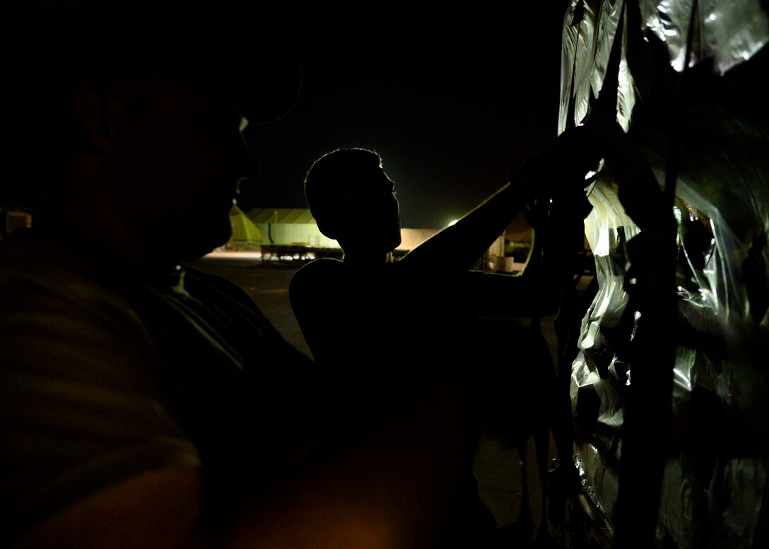 U.S. Air Force personnel secure the bindings on a pallet of cots to be sent to Al Udeid Air Base, Qatar, at Prince Sultan Air Base, Kingdom of Saudi Arabia, Aug. 20, 2021. The 378th Air Expeditionary Wing provided air support, logistics, manpower and resources to U.S. Air Forces Central in support of the evacuation of American citizens, special immigrant visa applicants and other at-risk individuals from Afghanistan. (U.S. Air Force photo by Senior Airman Samuel Earick)