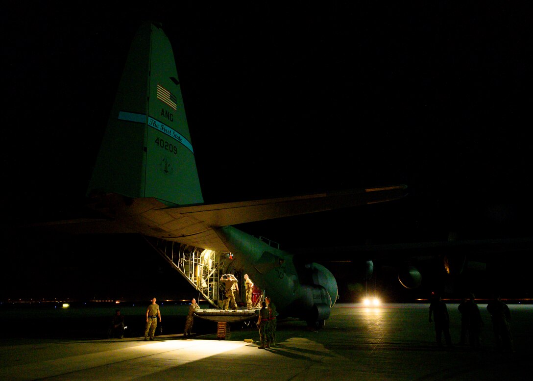 U.S. Air Force personnel load cargo onto a C-130 Hercules on the flightline at Prince Sultan Air Base, Kingdom of Saudi Arabia, prior to takeoff for Al Udeid Air Base, Qatar, Aug. 21, 2021. The 378th Air Expeditionary Wing provided air support, logistics, manpower and resources to U.S. Air Forces Central command in support of the evacuation of American citizens, special immigrant visa applicants and other at-risk individuals from Afghanistan. (U.S. Air Force photo by Senior Airman Samuel Earick)