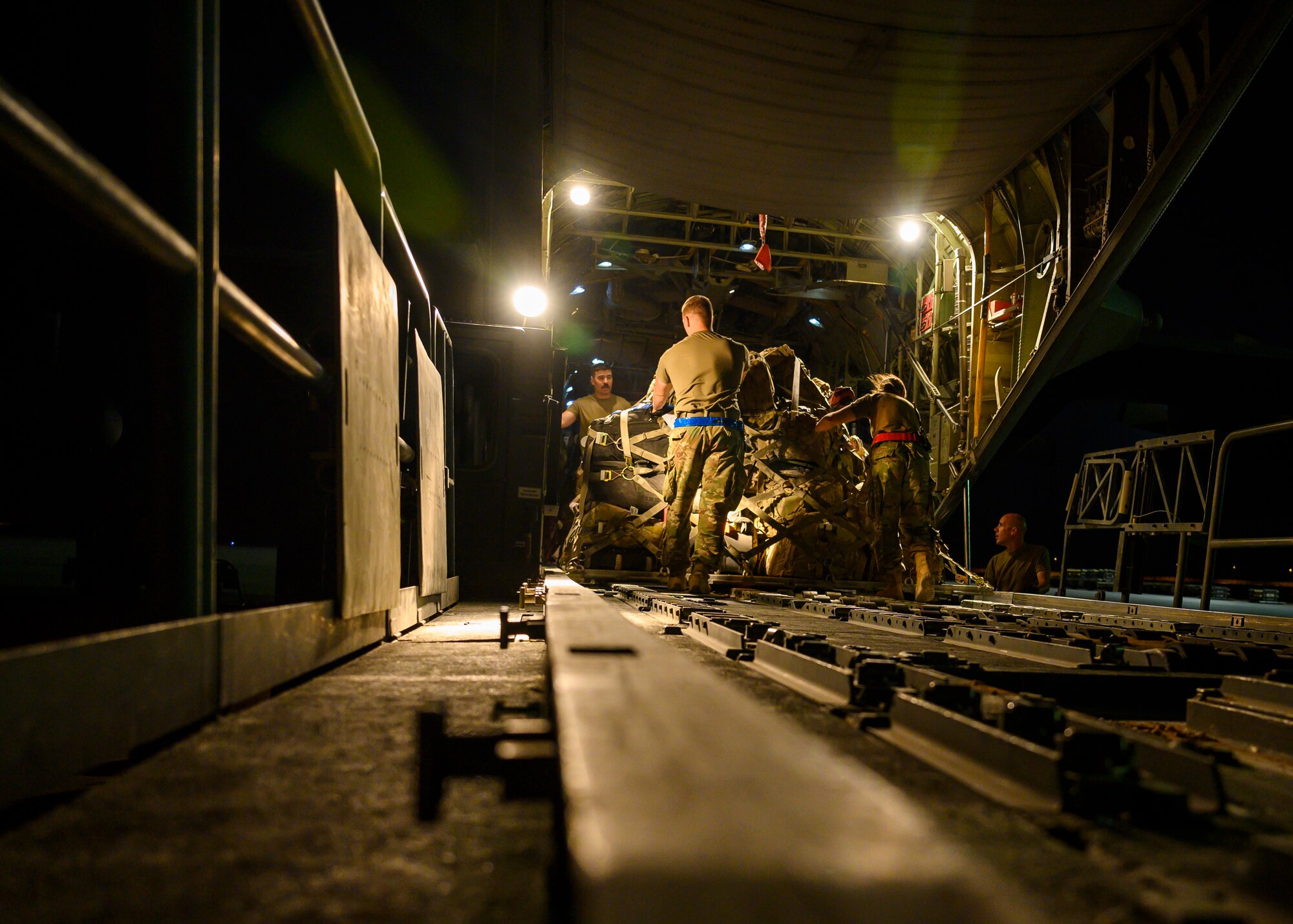 U.S. Air Force members load a pallet of personal gear and equipment onto a C-130 Hercules on the flightline at Prince Sultan Air Base, Kingdom of Saudi Arabia, prior to if taking off for Al Udeid Air Base, Qatar, Aug. 21, 2021. The 378th Air Expeditionary Wing provided air support, logistics, manpower and resources to U.S. Air Forces Central in support of the evacuation of American citizens, special immigrant visa applicants and other at-risk individuals from Afghanistan. (U.S. Air Force photo by Senior Airman Samuel Earick)