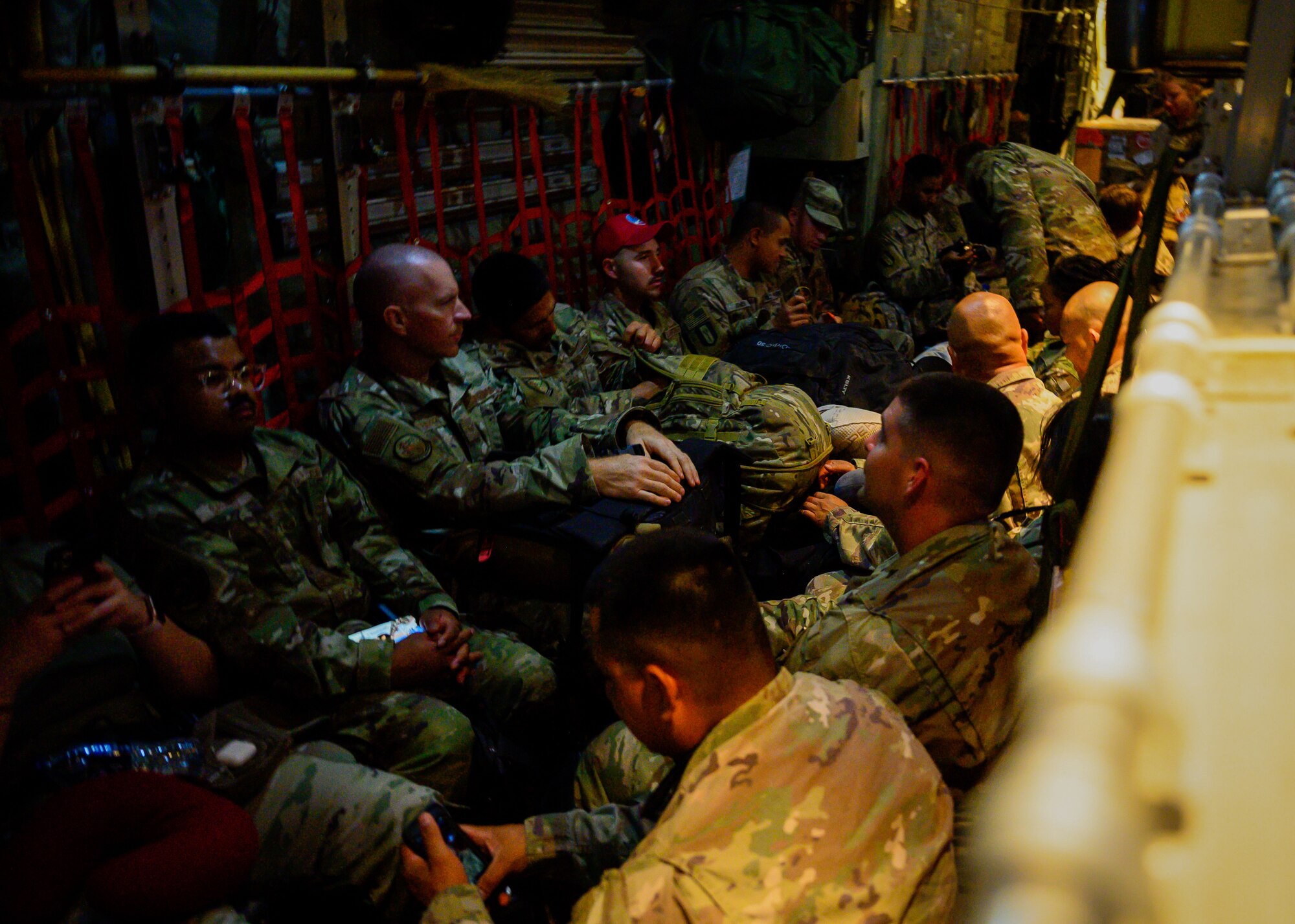 U.S. Air Force personnel settle into their seats aboard a C-130 Hercules on the flightline at Prince Sultan Air Base, Kingdom of Saudi Arabia, prior to takeoff for Al Udeid Air Base, Qatar, Aug. 21, 2021. The 378th Air Expeditionary Wing provided air support, logistics, manpower and resources to U.S. Air Forces Central in support of the evacuation of American citizens, special immigrant visa applicants and other at-risk individuals from Afghanistan. (U.S. Air Force photo by Senior Airman Samuel Earick)
