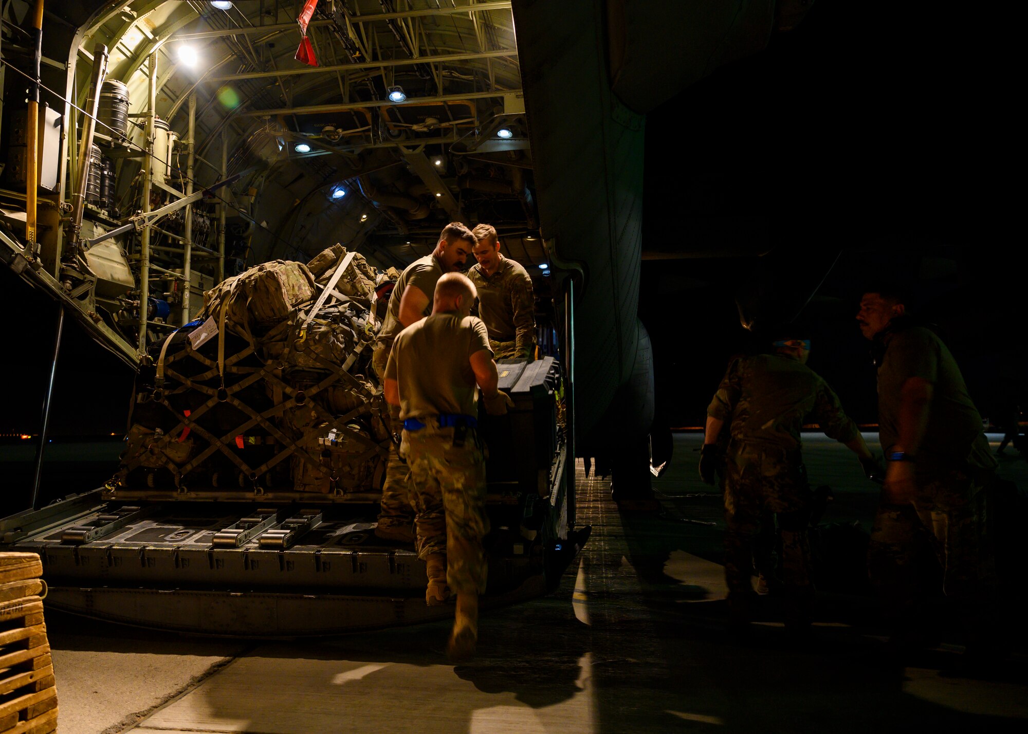 U.S. Air Force members load a pallet of personal gear and equipment onto a C-130 Hercules on the flightline at Prince Sultan Air Base, Kingdom of Saudi Arabia, prior to takeoff for Al Udeid Air Base, Qatar, Aug. 21, 2021. The 378th Air Expeditionary Wing provided air support, logistics, manpower and resources to U.S. Air Forces Central in support of the evacuation of American citizens, special immigrant visa applicants and other at-risk individuals from Afghanistan. (U.S. Air Force photo by Senior Airman Samuel Earick)