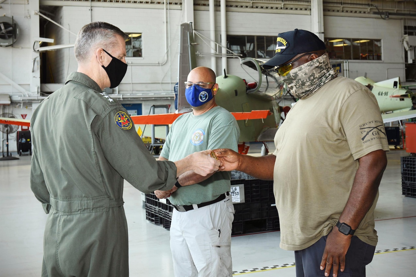210429-N-DG679-023 

JACKSONVILLE, Fla. (April 29, 2021) During Fleet Readiness Center Southeast’s (FRCSE) Micro Boots on the Ground event, Vice Adm. Dean Peters, commander, Naval Air Systems Command, presents coins to Thomas Fotos (left), a Trainers Production Line Work Leader for T-6 aircraft and Danny Carlisle (right), a Trainers Production Line Work Leader for T-44 aircraft, Apr. 29, 2021. Presenting coins is a customary military practice that acknowledges a person’s outstanding contributions to the mission. (U.S. Navy Photo by Toiete Jackson/Released)