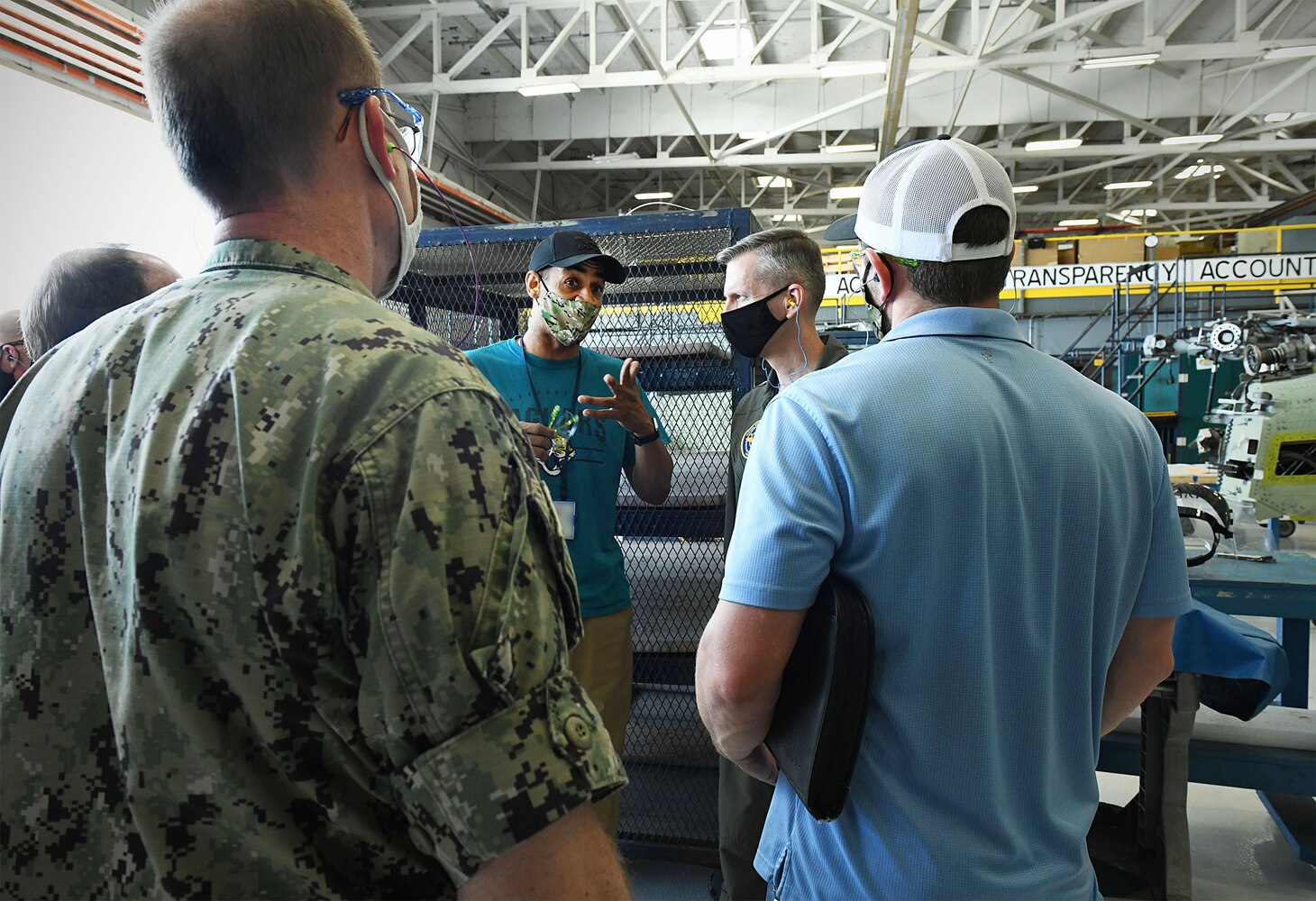 210429-N-DG679-107
MAYPORT, Fla. (April 29, 2021) Vice Adm. Dean Peters, commander, Naval Air Systems Command, fist bumps Combined Trades Leader Tomias Moore after presenting him a coin during his closing remarks following a tour of Fleet Readiness Center Southeast’s (FRCSE) Vertical Lift Production Line at Naval Station Mayport. Vice Adm. Dean Peters visited FRCSE as part of a Micro Boots on the Ground event, Apr. 29, 2021. (U.S. Navy Photo by Toiete Jackson/Released)