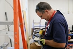 IMAGE: Alan Poulter, a maintenance mechanic with Naval Facilities Engineering Systems Command (NAVFAC), helps renovate an office space in Hopper Hall—NSWCDD DNA’s main building in Virginia Beach, Va. The DNA Facilities Team was able to establish a Memorandum of Understanding with NAVFAC to obtain four dedicated staff members who work onsite to help maintain and modernize the command’s facilities.