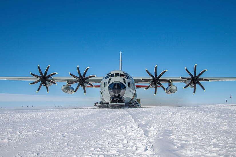 A large aircraft sits on snow.