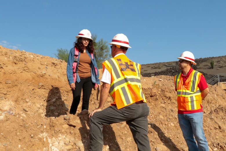 The U.S. Army Corps of Engineers Los Angeles District is working with the Flood Control District of Maricopa County, Arizona, to repair five levee systems using the Public Law 84-99 Rehabilitation and Inspection Program.

Work is currently underway in the New River Dam outlet channel in Peoria.

Here, Victoria Jurado (left), a geologist with the LA District, Jim Terstriep, a district construction representative, and Elvis Garay, a district project engineer, discuss the channel subgrade Sept. 28.