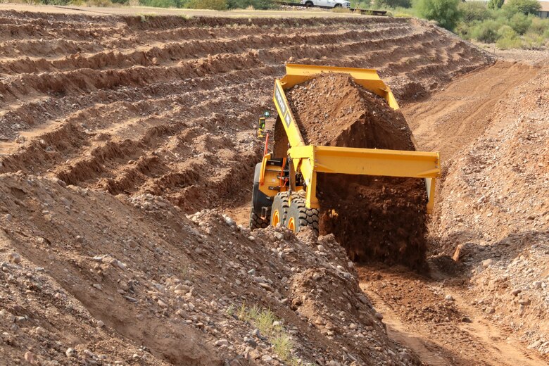 The U.S. Army Corps of Engineers Los Angeles District is working with the Flood Control District of Maricopa County, Arizona, to repair five levee systems using the Public Law 84-99 Rehabilitation and Inspection Program.

Work is currently underway in the New River Dam outlet channel in Peoria.

Here, a dump truck delivers fill to the channel subgrade Sept. 28.