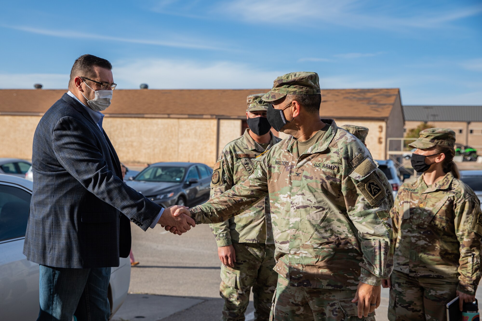Jeffrey Mayfield, left, Department of Homeland Security deputy federal coordinator, greets U.S. Army Col. Anthony T. Walters, U.S. Army North, during a visit to Holloman Air Force Base, New Mexico, Sept. 23, 2021. The Department of Defense, through U.S. Northern Command, and in support of the Department of State and Department of Homeland Security, is providing transportation, temporary housing, medical screening, and general support for at least 50,000 Afghan evacuees at suitable facilities, in permanent or temporary structures, as quickly as possible. This initiative provides Afghan evacuees essential support at secure locations outside Afghanistan. (U.S. Army photo by Pfc. Anthony Sanchez)