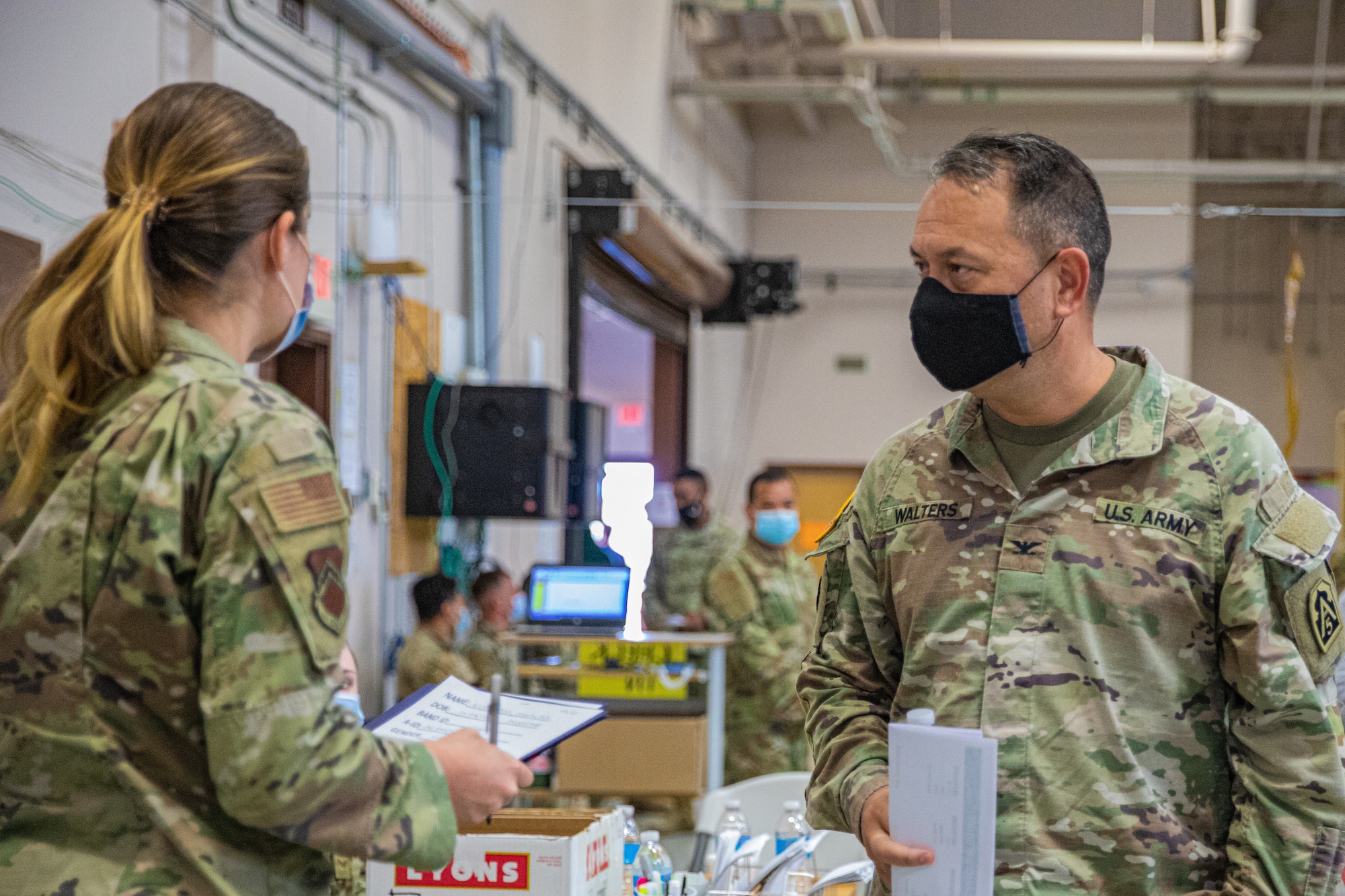 U.S. Army Col. Anthony T. Walters, right, U.S. Army North, walks through the Case Processing Facility as part of a visit to Holloman Air Force Base, New Mexico, Sept. 23, 2021. The Department of Defense, through U.S. Northern Command, and in support of the Department of State and Department of Homeland Security, is providing transportation, temporary housing, medical screening, and general support for at least 50,000 Afghan evacuees at suitable facilities, in permanent or temporary structures, as quickly as possible. This initiative provides Afghan evacuees essential support at secure locations outside Afghanistan. (U.S. Army photo by Pfc. Anthony Sanchez)