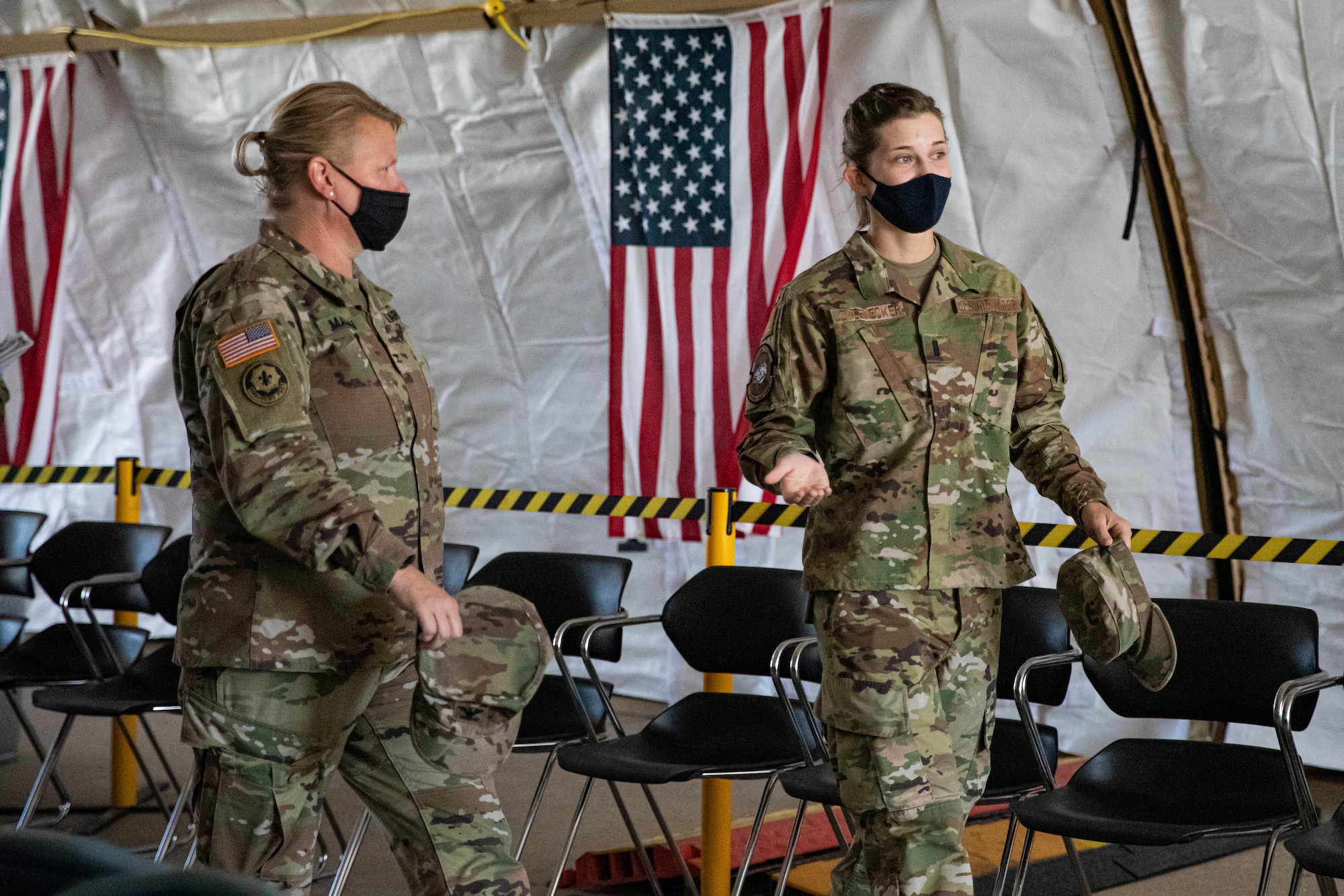 U.S. Air Force 1st Lt. Whitney Longenecker, right, Task Force Holloman Initial Processing Center officer in charge, briefs U.S. Army Col. Alicia Masson, U.S. Army North, during a visit to Holloman Air Force Base, New Mexico, Sept. 23, 2021. The Department of Defense, through U.S. Northern Command, and in support of the Department of State and Department of Homeland Security, is providing transportation, temporary housing, medical screening, and general support for at least 50,000 Afghan evacuees at suitable facilities, in permanent or temporary structures, as quickly as possible. This initiative provides Afghan evacuees essential support at secure locations outside Afghanistan. (U.S. Army photo by Pfc. Anthony Sanchez)