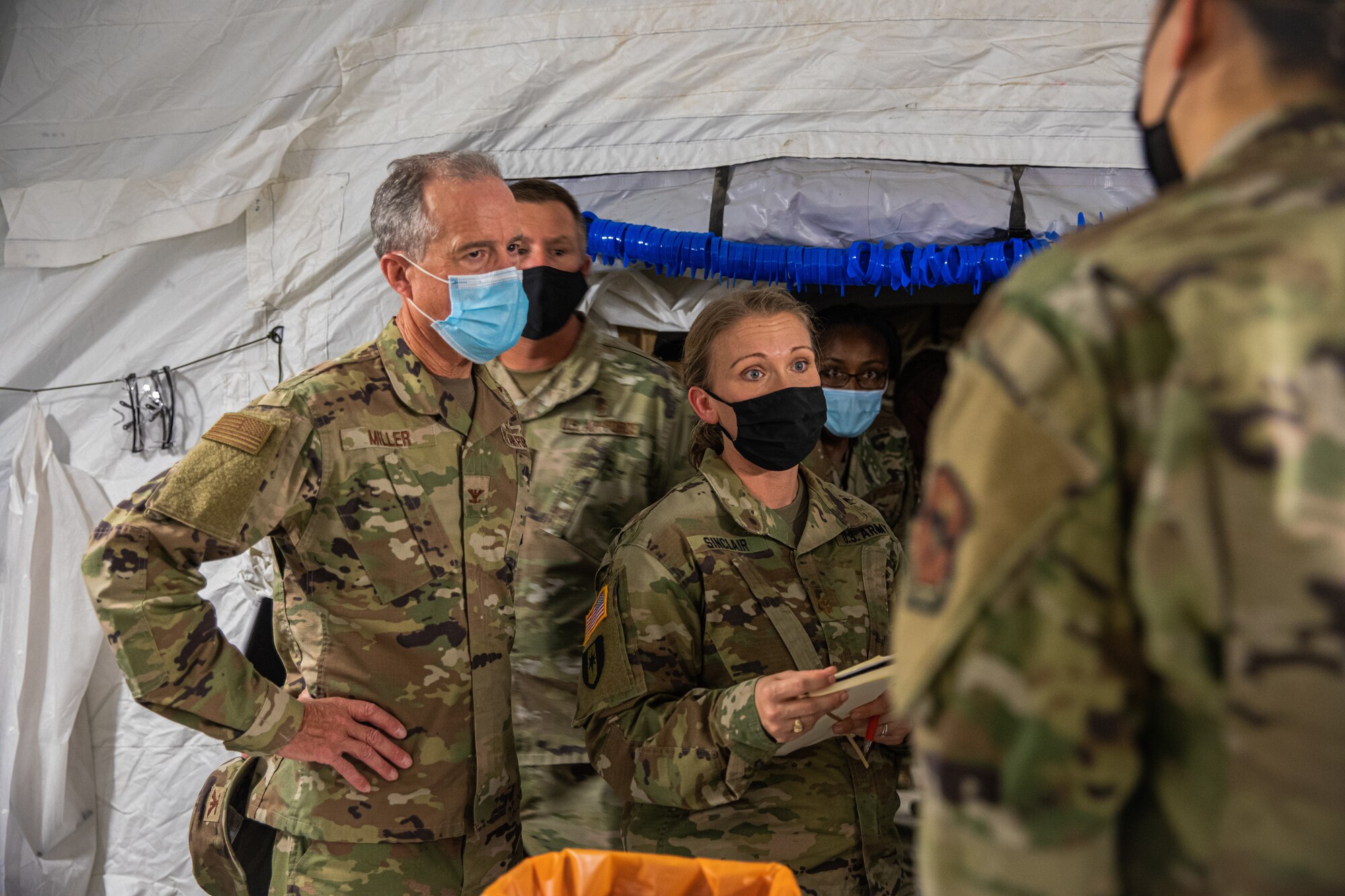 U.S. Army Maj. Rebecca Sinclair, U.S. Army North, receives a brief from Task Force-Holloman medical personnel during a visit to Holloman Air Force Base, New Mexico, Sept. 23, 2021. The Department of Defense, through U.S. Northern Command, and in support of the Department of State and Department of Homeland Security, is providing transportation, temporary housing, medical screening, and general support for at least 50,000 Afghan evacuees at suitable facilities, in permanent or temporary structures, as quickly as possible. This initiative provides Afghan evacuees essential support at secure locations outside Afghanistan. (U.S. Army photo by Pfc. Anthony Sanchez)U.S. Army Maj. Rebecca Sinclair, U.S. Army North, receives a brief from Task Force-Holloman medical personnel during a visit to Holloman Air Force Base, New Mexico, Sept. 23, 2021. The Department of Defense, through U.S. Northern Command, and in support of the Department of State and Department of Homeland Security, is providing transportation, temporary housing, medical screening, and general support for at least 50,000 Afghan evacuees at suitable facilities, in permanent or temporary structures, as quickly as possible. This initiative provides Afghan evacuees essential support at secure locations outside Afghanistan. (U.S. Army photo by Pfc. Anthony Sanchez)