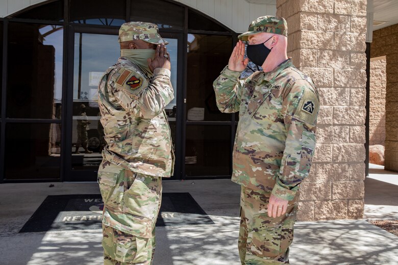 U.S. Air Force Lt. Col. Dwayne Jones, left, Task Force Holloman chaplain, salutes U.S. Army Col. Stan Whitten, U.S. Army North chaplain, after receiving a coin at the conclusion to a tour through TF Holloman on Holloman Air Force Base, New Mexico, Sept. 22, 2021. The Department of Defense, through the U.S. Northern Command, and in support of the Department of State and Department of Homeland Security, is providing transportation, temporary housing, medical screening, and general support for at least 50,000 Afghan evacuees at suitable facilities, in permanent or temporary structures, as quickly as possible. This initiative provides Afghan evacuees essential support at secure locations outside Afghanistan. (U.S. Army photo by Spc. Nicholas Goodman)