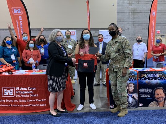 Col. Antoinette Gant, commander of the South Pacific Division, right, along with other Division and District leaders, presents a letter of intent to Anabella Noguera, a senior civil engineering student at the University of California-Los Angeles, during the American Indian Science and Engineering Society National Conference Sept. 24 in Phoenix.