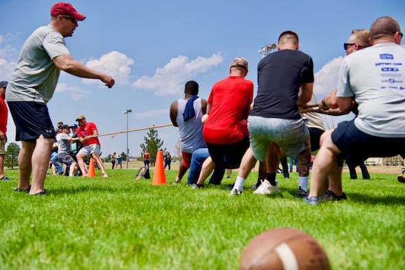 Members of Schriever Space Force Base, Colorado, fight a battle of tug-of-war during the biannual Wingman Day, Aug. 6, 2021. Wingman Day was established in October 2004 by U.S. Air Force Gen. John P. Jumper, the 17th Chief of Staff of the Air Force, to impress a culture within the Air Force of Airmen taking care of Airmen, and now to include U.S. Space Force Guardians. The term Wingman stems from a time-honored tradition within the Air Force that stresses the dedication between lead pilots and supporting pilots in formation. (U.S. Space Force Photo by Kristian DePue)