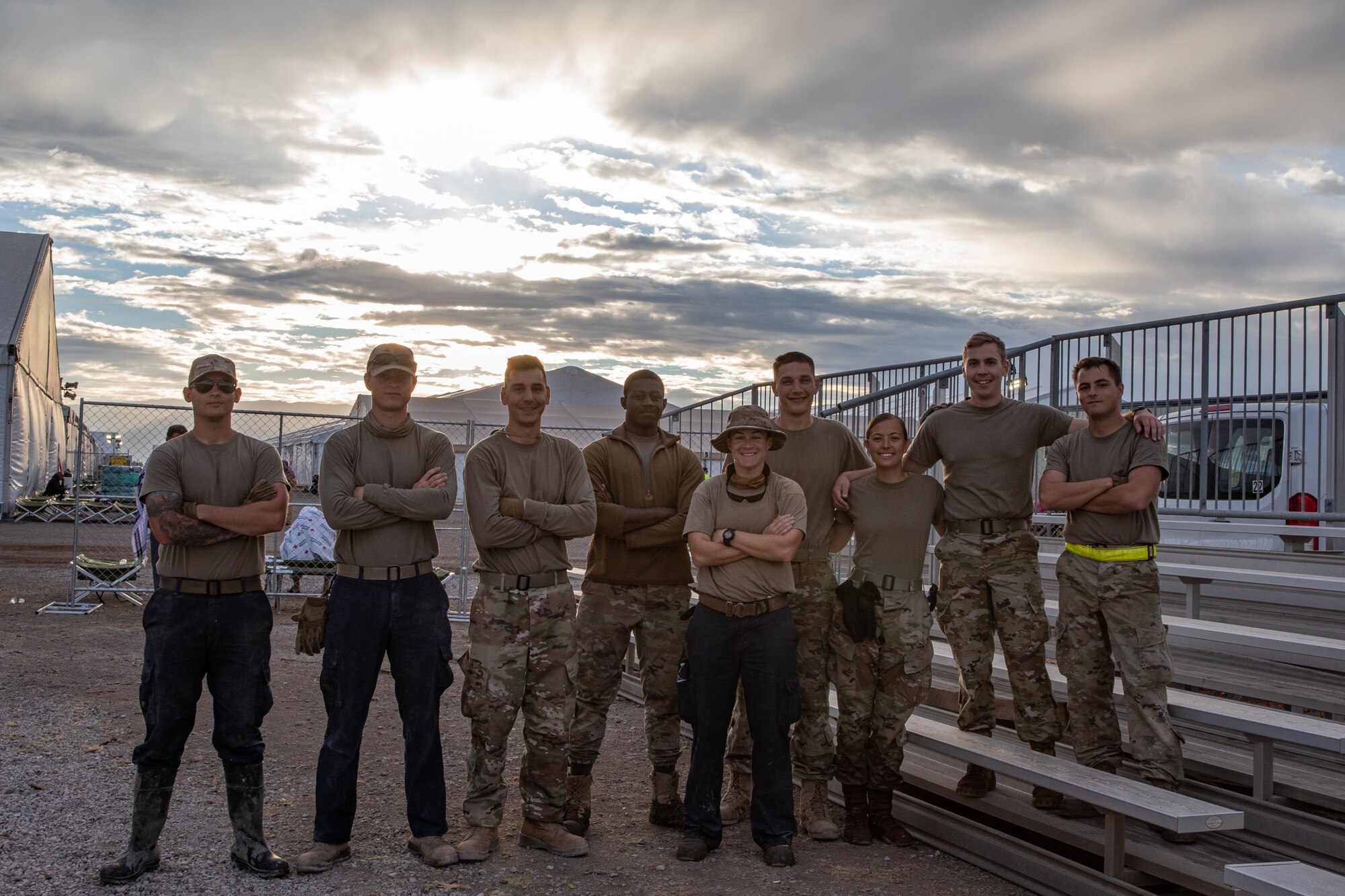 Airmen assigned to Task Force-Holloman pose for a group photo on Holloman Air Force Base, New Mexico, Sept. 24, 2021. The Department of Defense, through the U.S. Northern Command, and in support of the Department of State and Department of Homeland Security, is providing transportation, temporary housing, medical screening, and general support for at least 50,000 Afghan evacuees at suitable facilities, in permanent or temporary structures, as quickly as possible. This initiative provides Afghan evacuees essential support at secure locations outside Afghanistan. (U.S. Army photo by Spc. Nicholas Goodman)