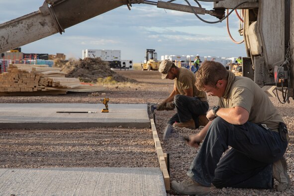 Airmen assigned to Task Force-Holloman prepare to pour concrete for a recreational area for Afghan evacuees on Holloman Air Force Base, New Mexico, Sept. 24, 2021. The Department of Defense, through the U.S. Northern Command, and in support of the Department of State and Department of Homeland Security, is providing transportation, temporary housing, medical screening, and general support for at least 50,000 Afghan evacuees at suitable facilities, in permanent or temporary structures, as quickly as possible. This initiative provides Afghan evacuees essential support at secure locations outside Afghanistan. (U.S. Army photo by Spc. Nicholas Goodman)