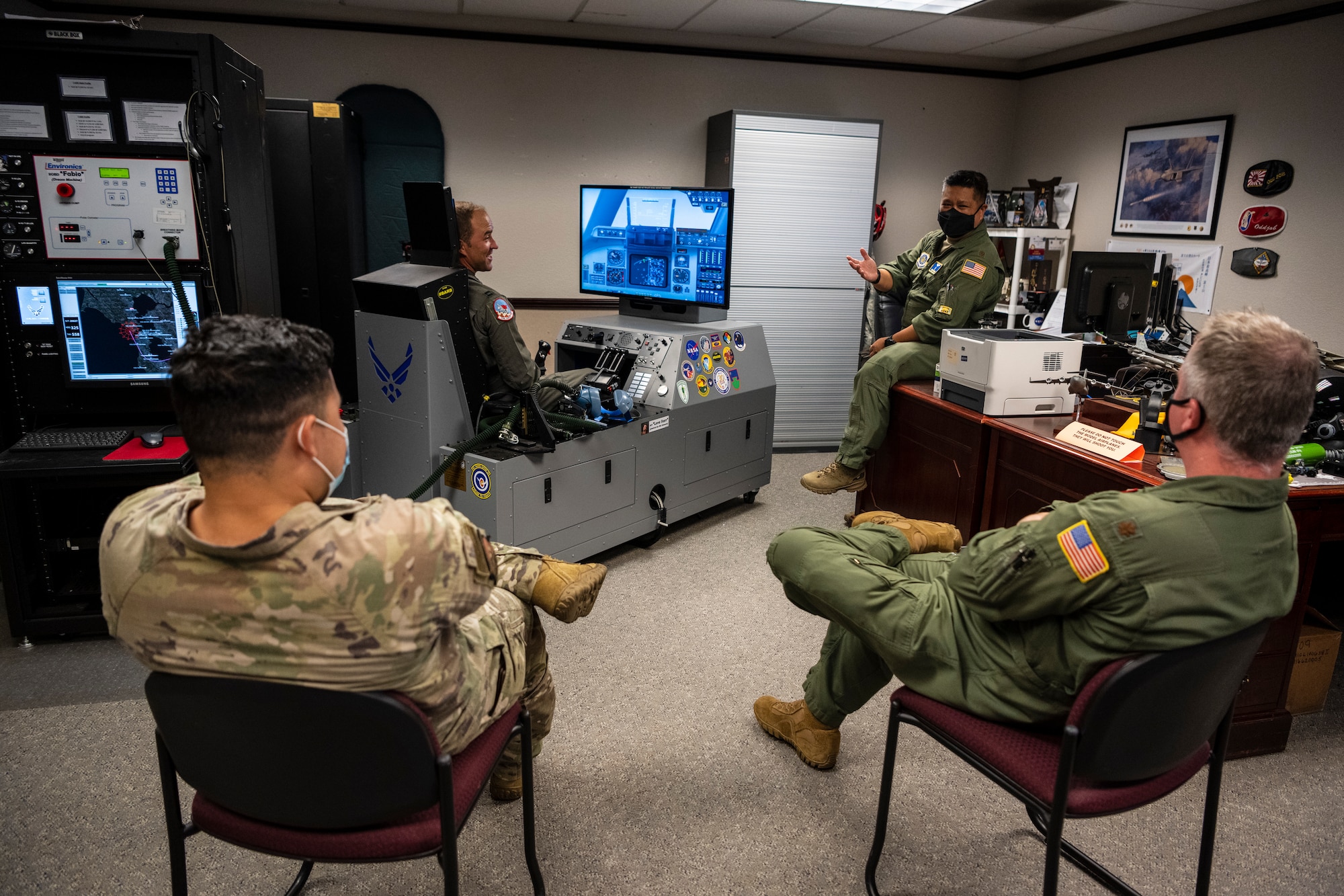 Airmen gathered in a classroom setting discussing aerospace medicine.