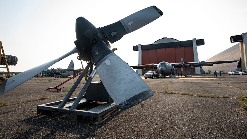 A photo of a C-130 Hercules engine sitting on the flightline.