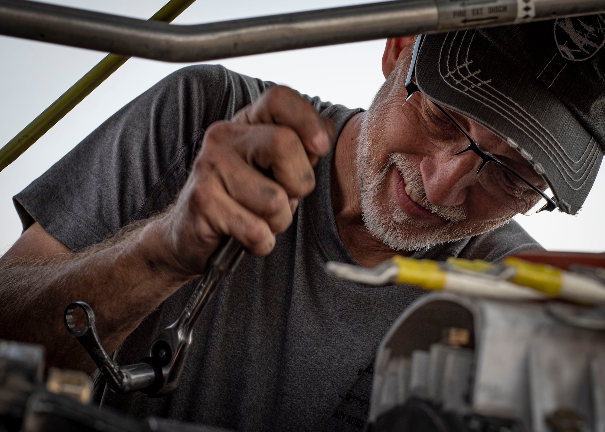 Photo of a contractor removing an engine valve.