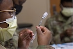 An Airman from the 6th Medical Group (MDG) prepares a COVID-19 vaccine for distribution at MacDill Air Force Base, Florida, Sept. 17, 2021. This is the second time the 6 MDG has established a point of distribution on base in order to help distribute roughly 1,000 COVID-19 vaccines per day. (U.S. Air Force photo by Airman 1st Class Hiram Martinez)