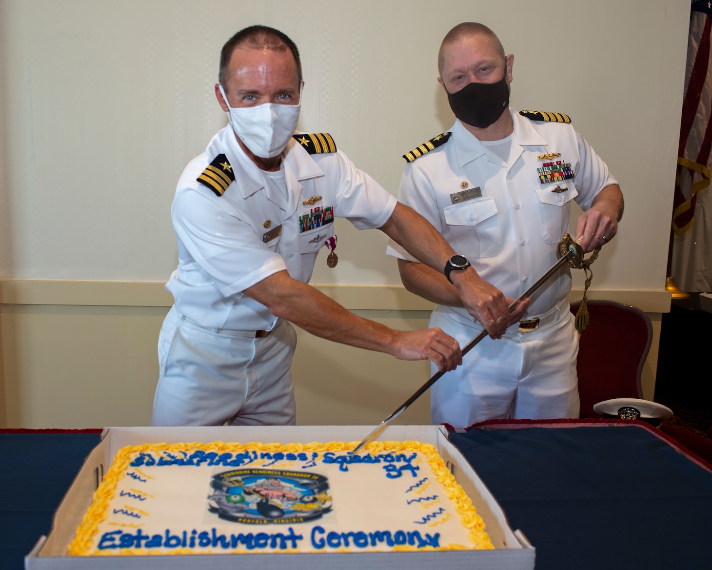 Cmdr. Bryan Christiansen, left, and Capt. Jeffrey Juergens, commander, Submarine Squadron 6, participate in a cake-cutting ceremony in recognition of the establishment of Submarine Readiness Squadron (SRS) 34 at Naval Station Norfolk, Sept. 30.