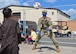 Man and child play with soccer ball