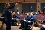 Deputy Master Chief Petty Officer of the Coast Guard Master Chief Charles “Rob” Bushey mentors the recruits of Charlie and Delta 200 inside of the Ida Lewis Auditorium during their visit to U.S. Coast Guard Training Center Cape May, N.J., Feb. 27, 2021.