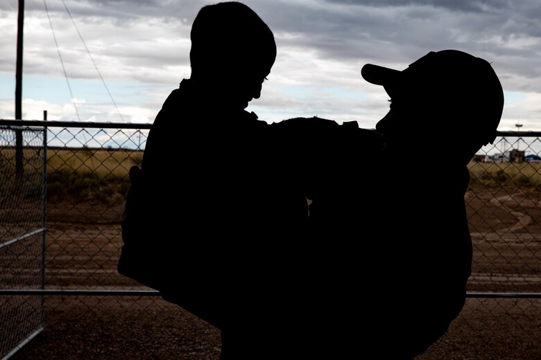 An Airman interacts with an Afghan evacuee child after their daily school lesson on Holloman Air Force Base, New Mexico, Sept. 28, 2021. The Department of Defense, through the U.S. Northern Command, and in support of the Department of State and Department of Homeland Security, is providing transportation, temporary housing, medical screening, and general support for at least 50,000 Afghan evacuees at suitable facilities, in permanent or temporary structures, as quickly as possible. This initiative provides Afghan evacuees essential support at secure locations outside Afghanistan. (U.S. Army photo by Spc. Nicholas Goodman)