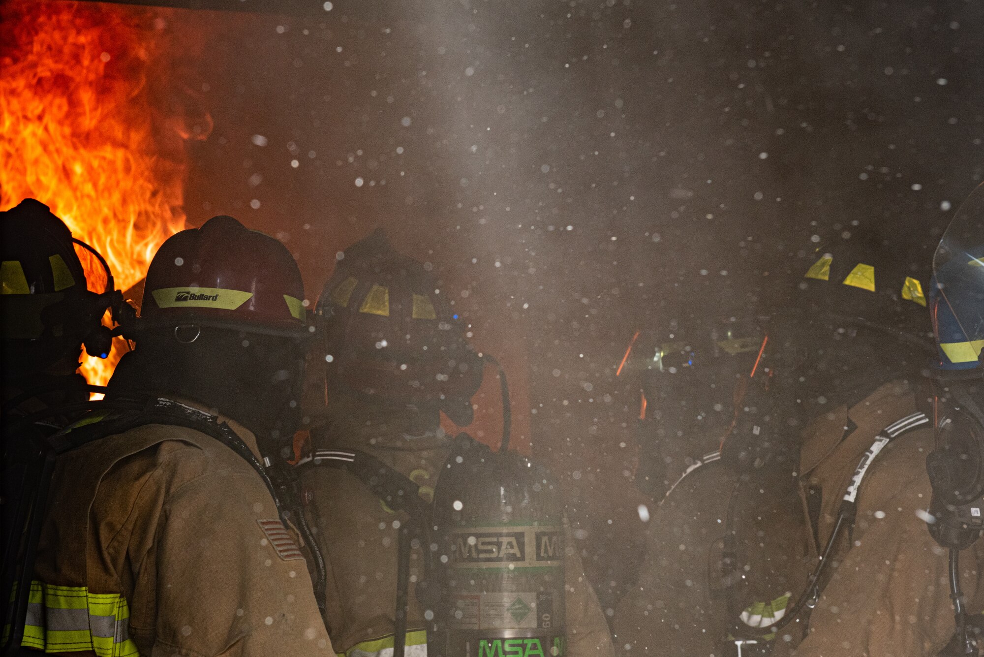 Firefighters from Task Force-Holloman train with members of the 49th Civil Engineer Squadron in a live-fire exercise Sept. 23, 2021 on Holloman Air Force Base, New Mexico. The training ensures TF-H members remain ready and improves interoperability in the event that a fire breaks out in Aman Omid Village. The Department of Defense, through U.S. Northern Command, and in support of the Department of State and Department of Homeland Security, is providing transportation, temporary housing, medical screening, and general support for at least 50,000 Afghan evacuees at suitable facilities, in permanent or temporary structures, as quickly as possible. This initiative provides Afghan evacuees essential support at secure locations outside Afghanistan. (U.S. Air Force photo by Staff Sgt. Kenneth Boyton)
