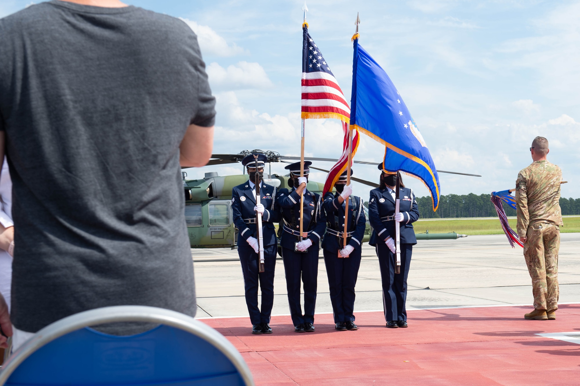 A photo of Airmen presenting flags.