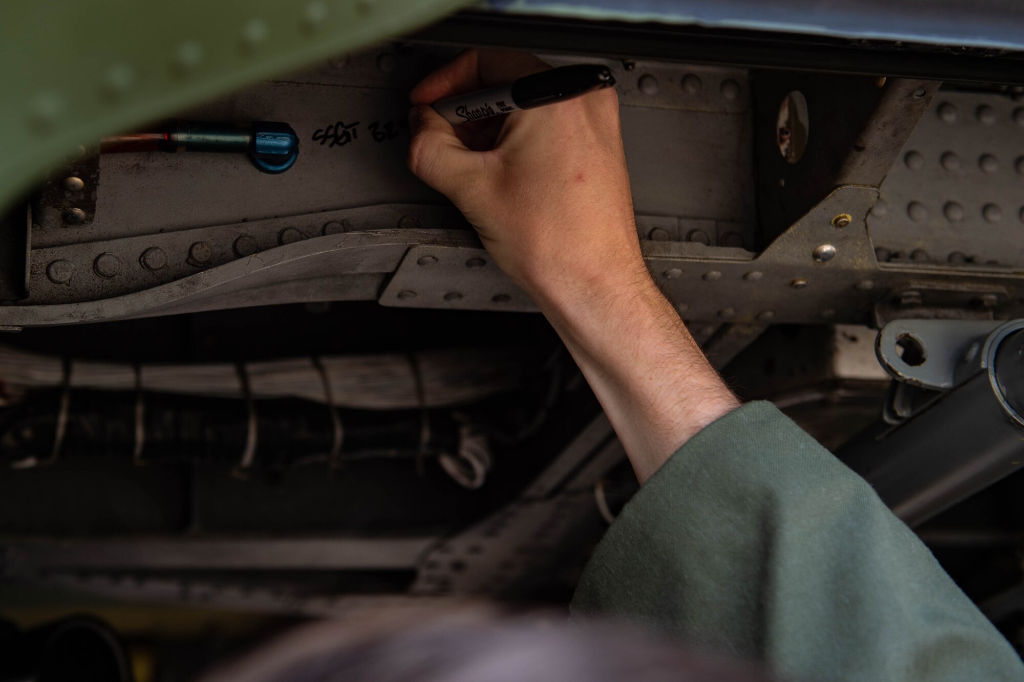 A photo of an Airman writing.