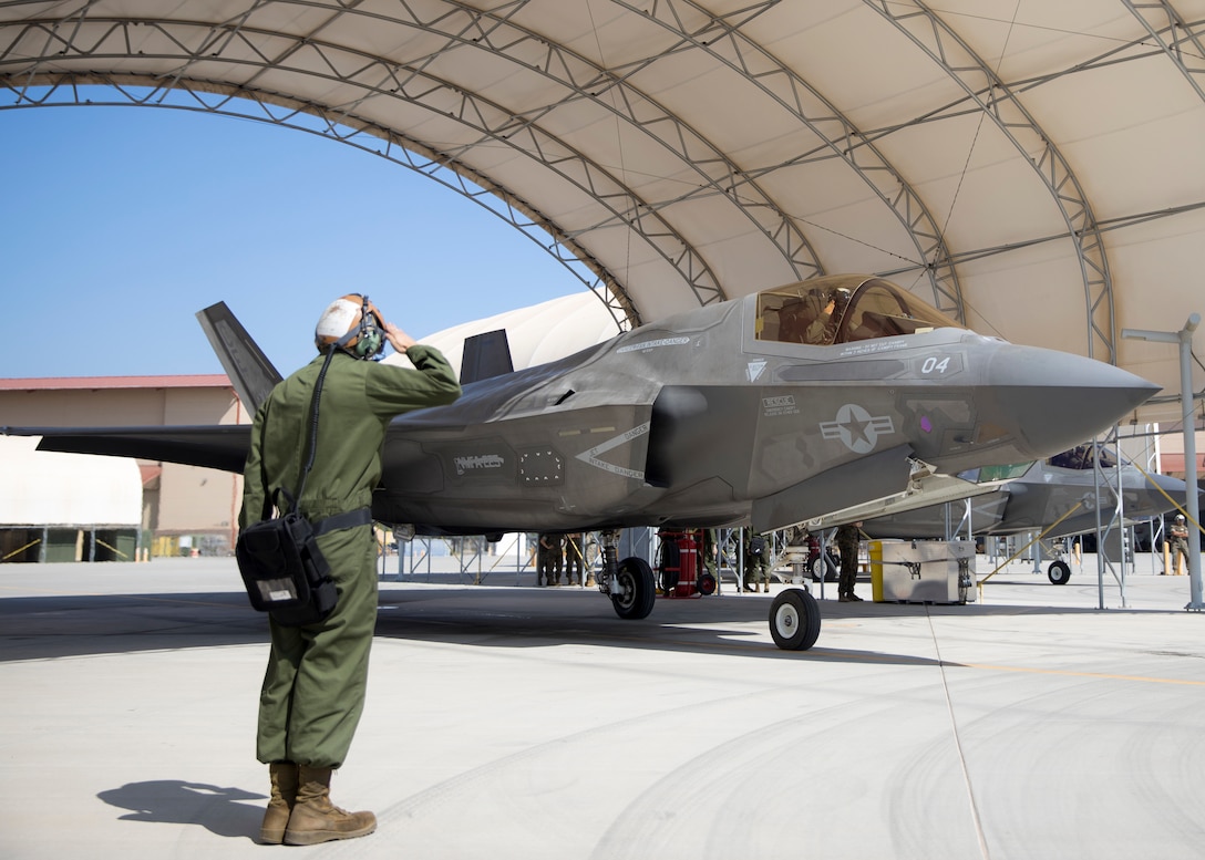 A U.S. Marine with Marine Fighter Attack Squadron (VMFA) 225 salutes Lt. Col. Alexander Goodno, commanding officer of VMFA 225, before takeoff at Marine Corps Air Station Yuma, Ariz., September 25, 2021. VMFA-225 participated in their first flight as an F-35B squadron. This marked the end of the first phase in the transition from a legacy F/A-18D Hornet squadron to an F-35B squadron. (U.S. Marine Corps Photo by Lance Cpl. Matthew Romonoyske-Bean)