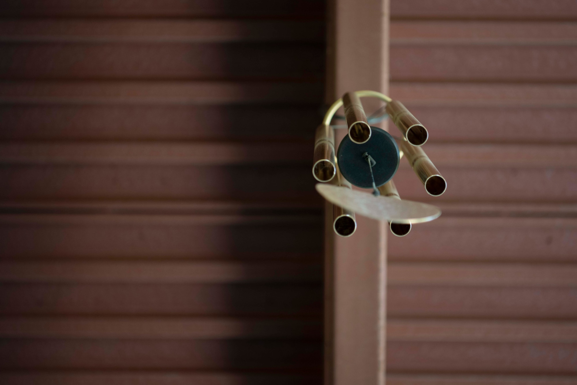 A wind chime attached to a roof